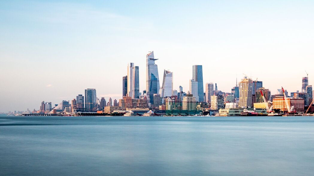 摩天大楼与蔚蓝大海交汇，城市码头美景4K高清壁纸（3840x2160）免费下载
